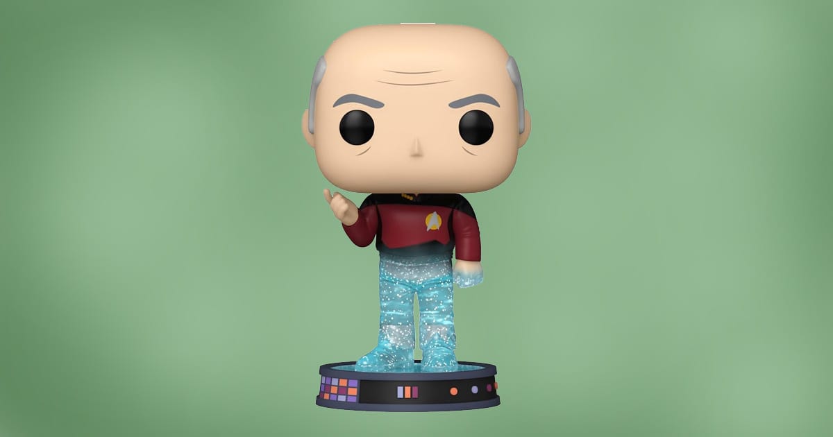 Funko Pop figure of Jean-Luc Picard from Star Trek: The Next Generation mid-transport on a glittery transporter base, wearing red Starfleet uniform, against green background.