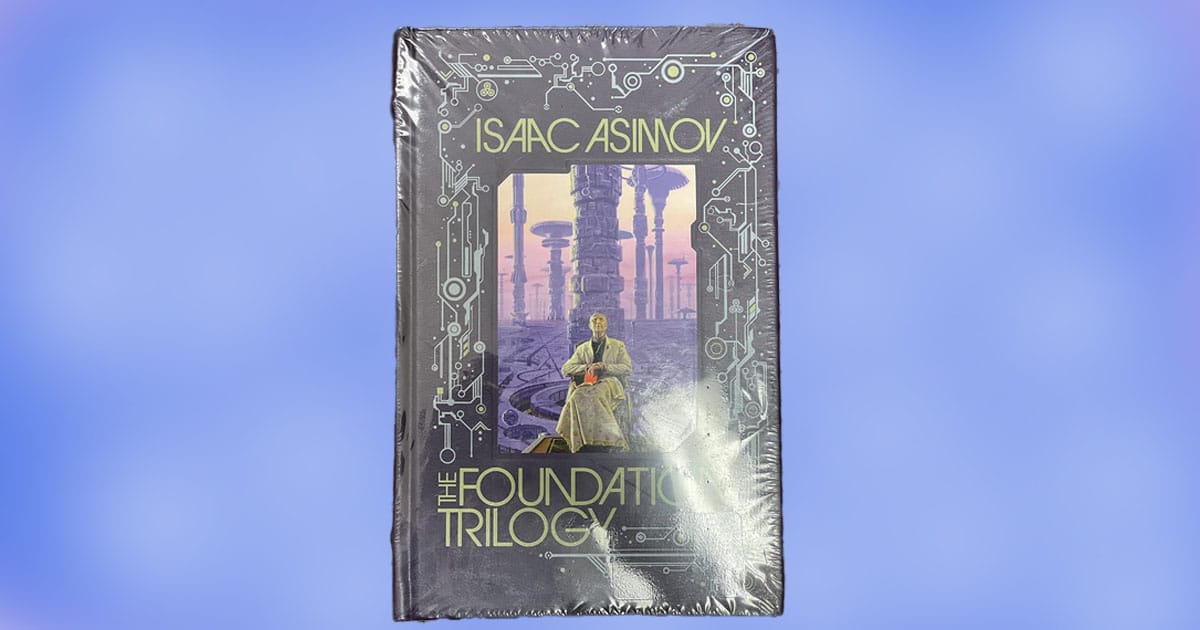 Cover of The Foundation Trilogy by Isaac Asimov featuring a seated figure in a futuristic city with circuit-themed border design.