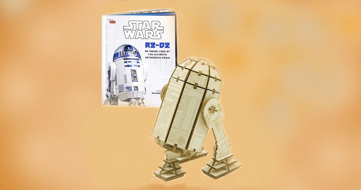 R2-D2 wooden model kit with illustrated booklet featuring Star Wars artwork and detailed droid history.