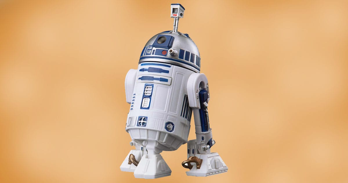 Hasbro Star Wars R2-D2 action figure with silver dome and retractable third leg against a neutral background.