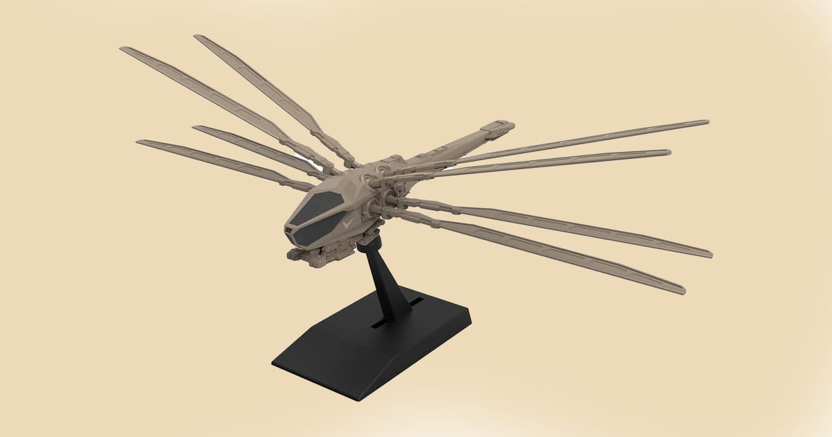 Model of the Atreides Ornithopter from Dune with extended wings mounted on a black display stand.
