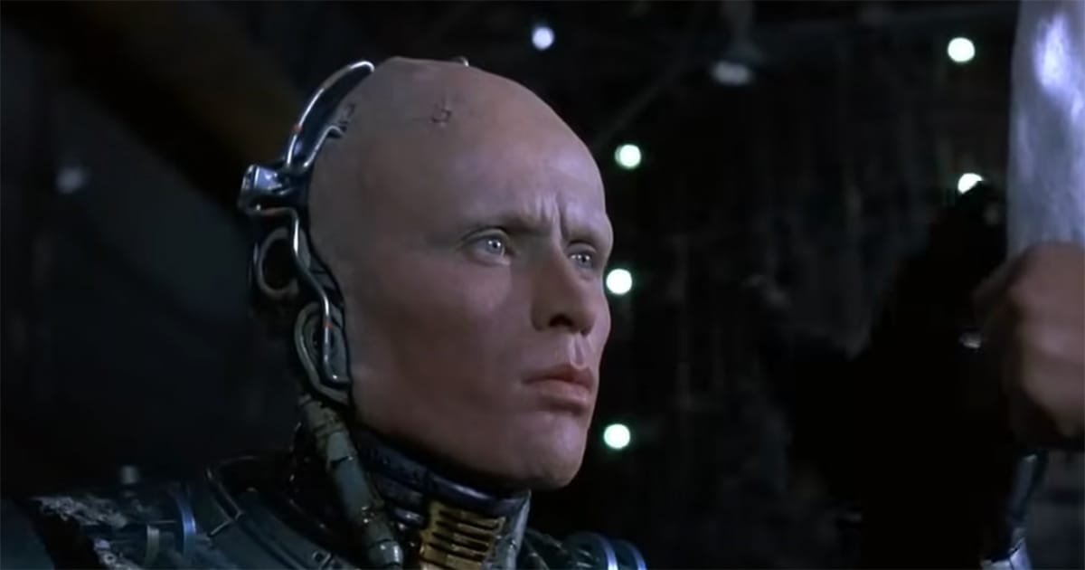 Close-up of RoboCop with his helmet removed, showing Alex Murphy’s human face alongside mechanical components, symbolizing the struggle between man and machine in the 1987 film "RoboCop."