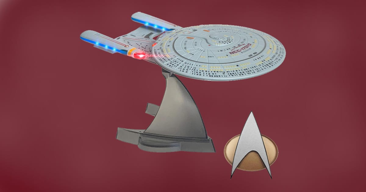 FAMETEK Star Trek TNG communicator badge with USS Enterprise Bluetooth speaker on display.