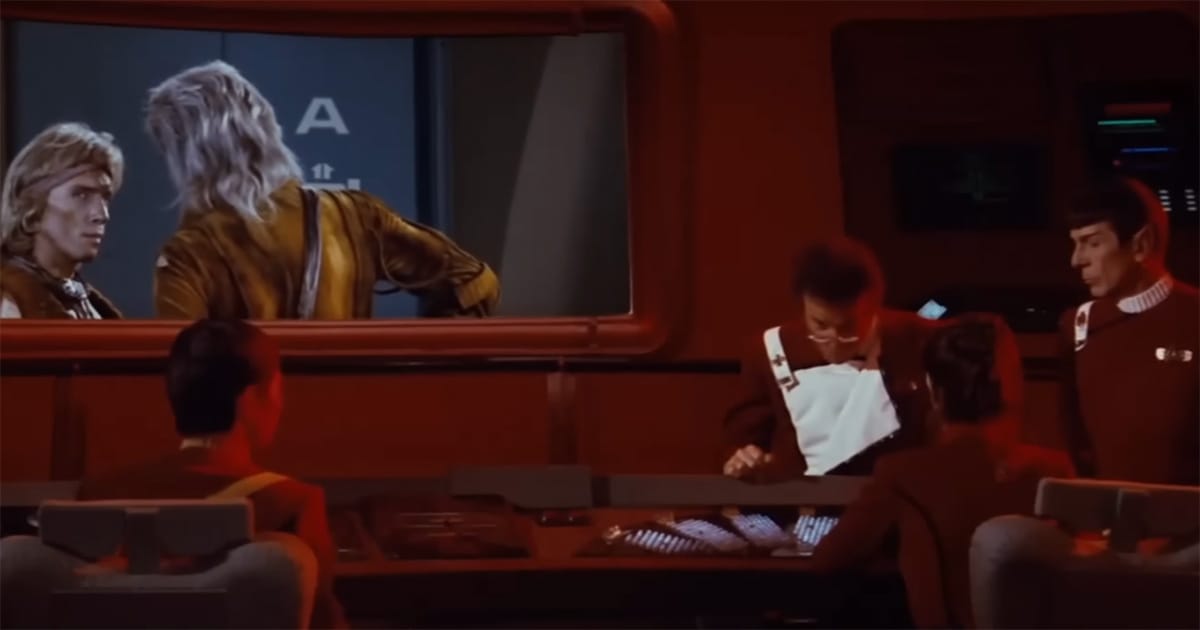 Khan’s back turned on the viewscreen as Kirk’s crew listens, highlighting the vast distance between adversaries in "The Wrath of Khan."