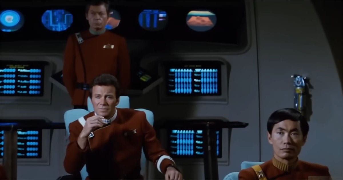 Kirk seated in deep thought on the bridge of the Enterprise, flanked by Sulu and McCoy, the storm behind them but not forgotten.