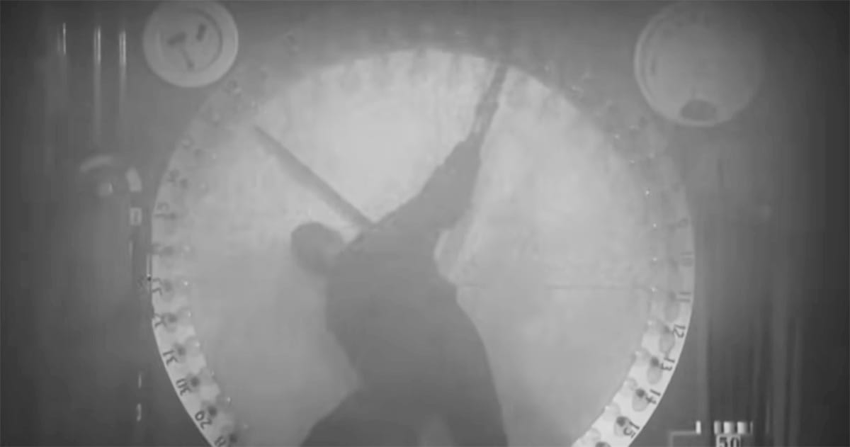 A worker in Metropolis (1927) straining to move giant clock hands, symbolizing the crushing demands of time and mechanized control.