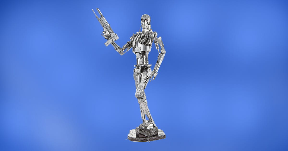 Metal Earth Terminator T-800 Endoskeleton 3D model kit fully assembled with chrome finish and plasma rifle on display base.