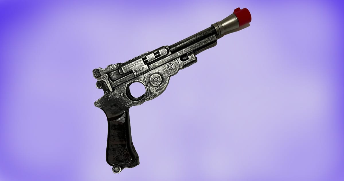 Han Solo full-size foam blaster replica with red safety tip on purple background.