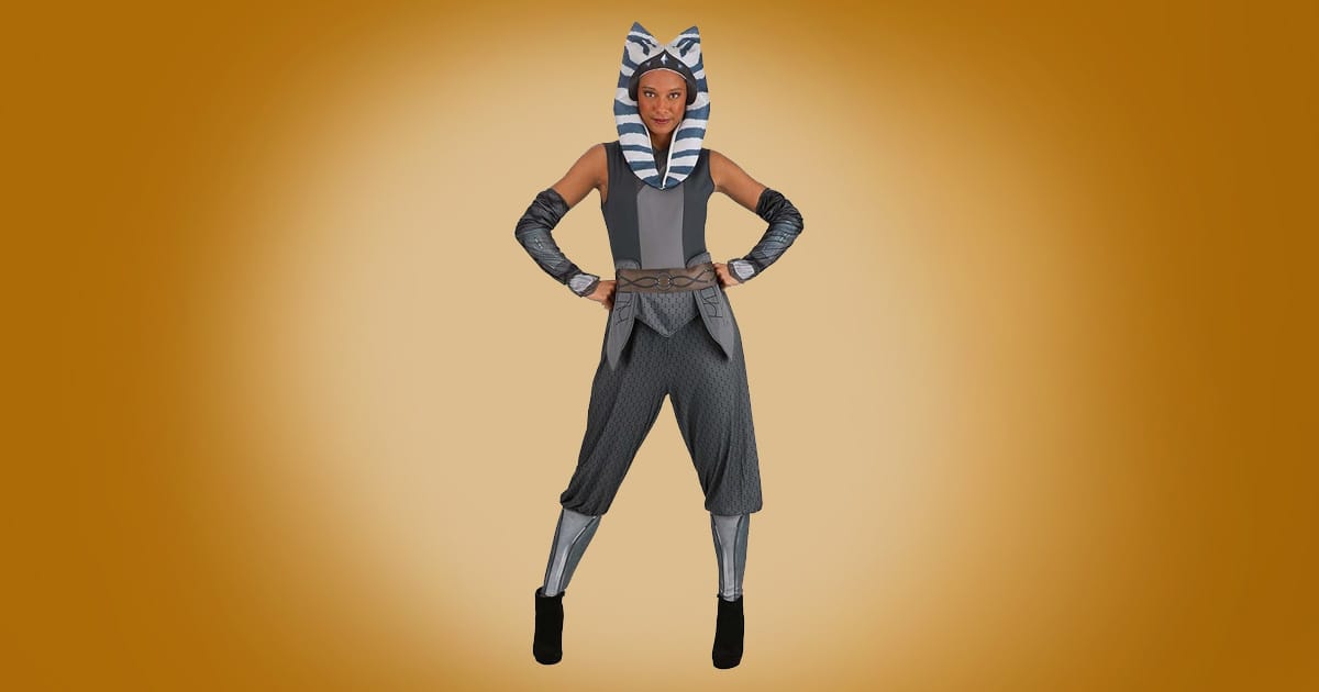 Adult Ahsoka Tano Star Wars costume with striped headpiece, gray tunic, belt, and arm guards on orange background.