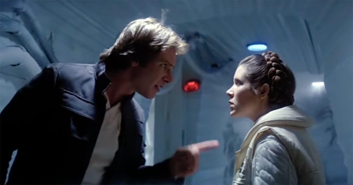 Han Solo points at Leia during an argument inside Echo Base, both framed by the blue light of Hoth’s frozen tunnels.