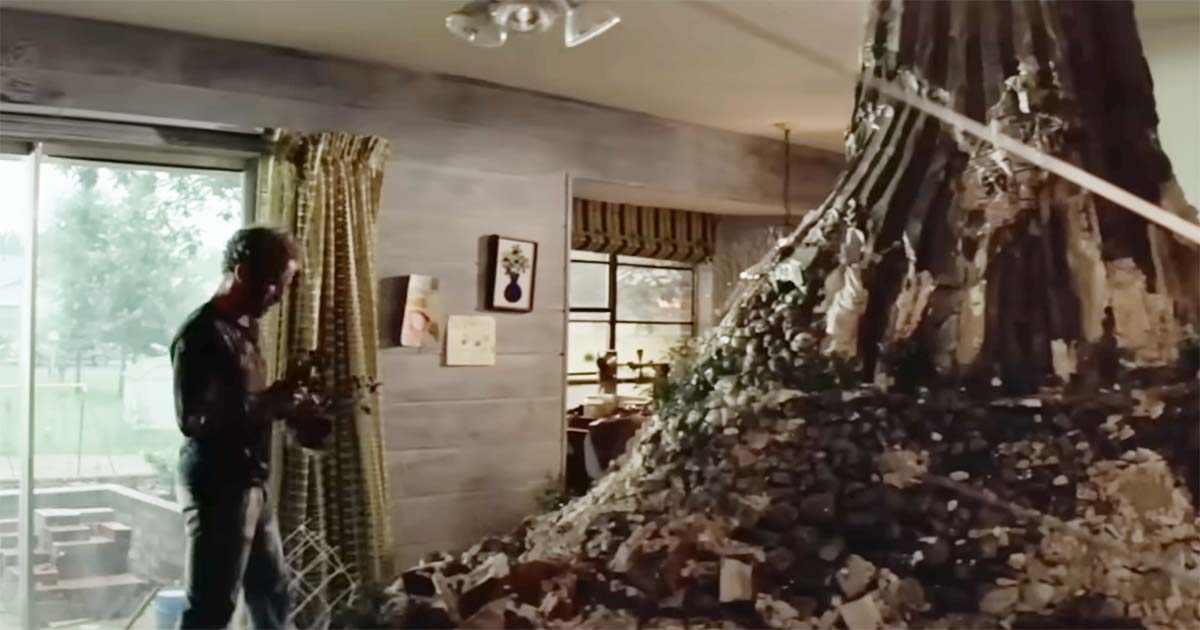A man builds a large model of Devil’s Tower inside his home in “Close Encounters of the Third Kind.”