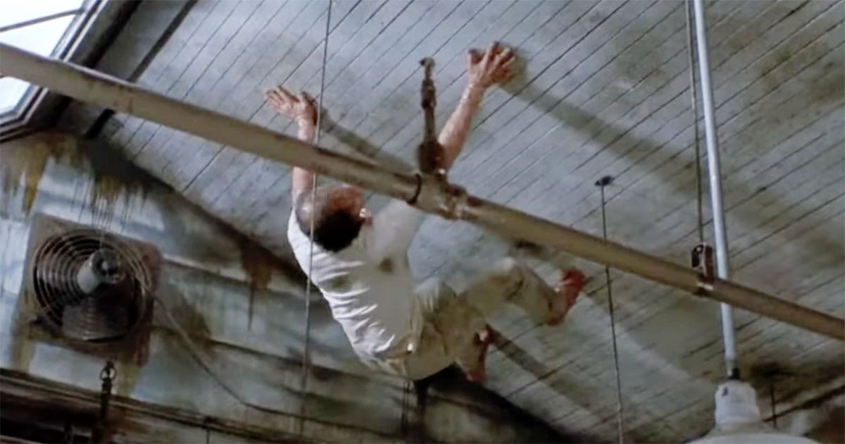 A man clings to the ceiling of his lab as his mutation takes hold.