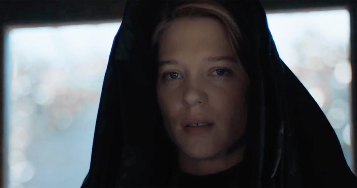 Lady Margot Fenring in a dark Bene Gesserit veil, her face calm and attentive, reflecting the composure and discipline of her training.