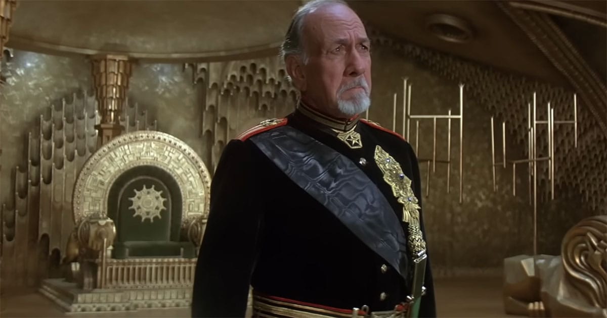 Emperor Shaddam IV portrayed by José Ferrer alone in the imperial throne room in Dune 1984.