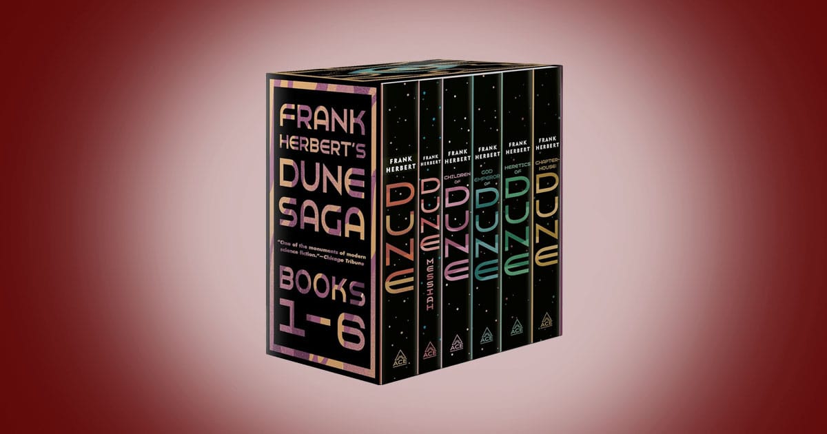 Boxed paperback set of Frank Herbert’s Dune Saga showing six matching volumes arranged in a slipcase, with dark star filled covers and minimalist typography, representing an epic science fiction series about power, destiny, and survival.