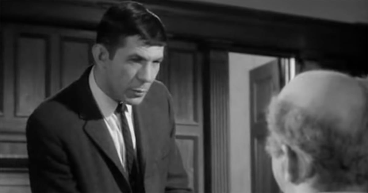 Leonard Nimoy in courtroom scene from Invasion of the Body Snatchers black and white film.