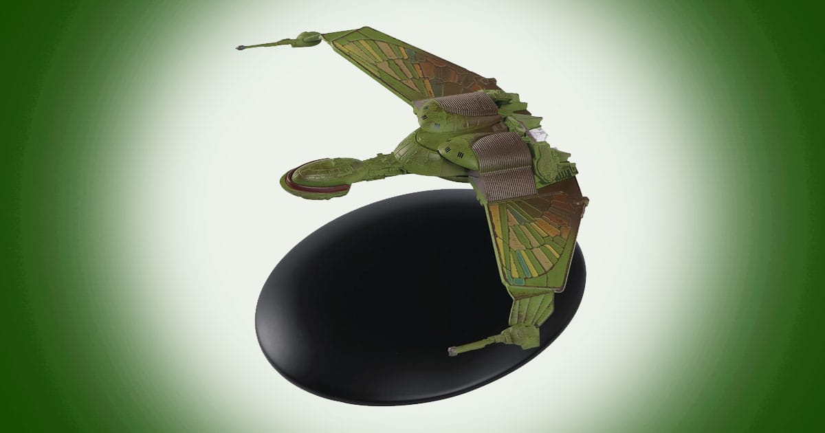 Model of Klingon Bird-of-Prey from Star Trek with green wings extended and detailed hull mounted on a display stand.