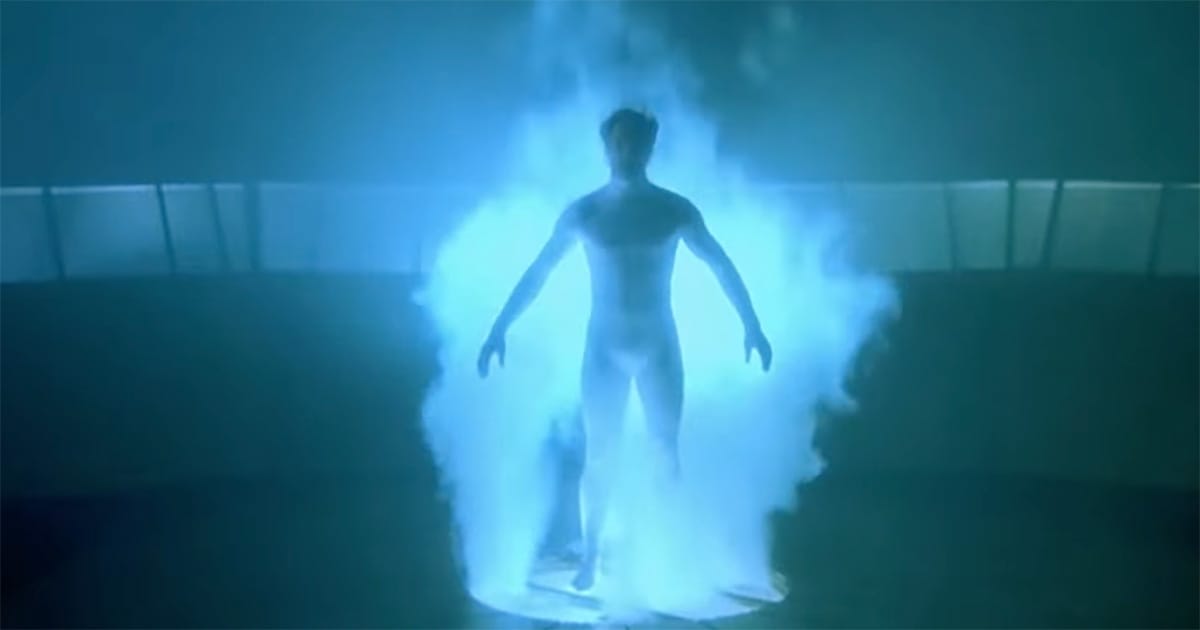 Sam Beckett standing in blue light inside accelerator during time travel in Quantum Leap.