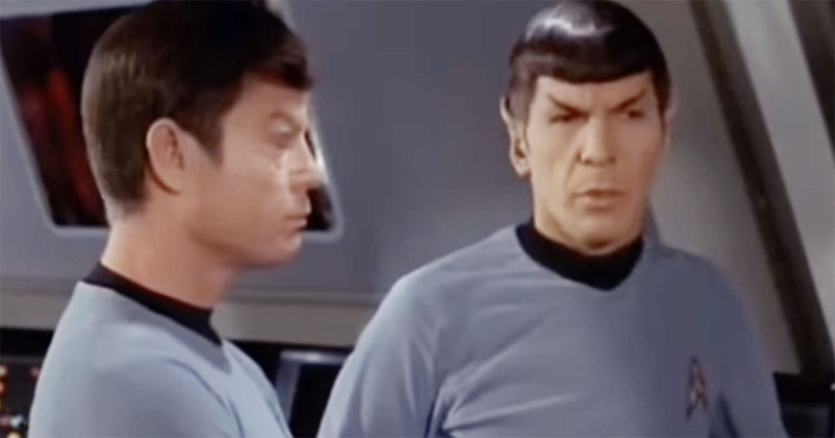 Spock and Leonard McCoy stand face to face in tense conversation aboard the Enterprise.