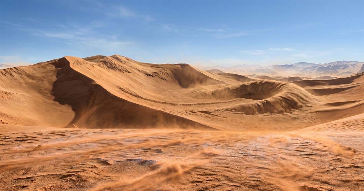 Wide desert landscape of Arrakis with rolling sand dunes and a disturbed surface area suggesting spice beneath the sand.