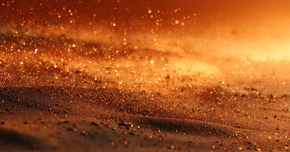 Close-up of fine orange-brown powder particles drifting in desert air, resembling spice melange from Dune.