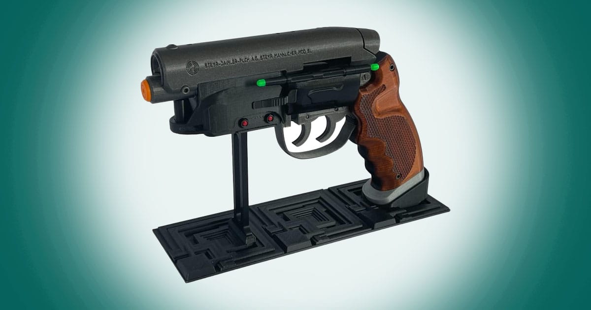 Blade Runner blaster replica displayed on a stand featuring detailed grip and futuristic hybrid firearm design.