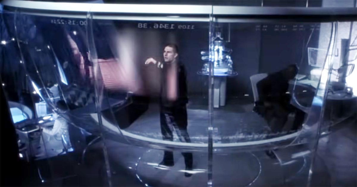 Tom Cruise operating futuristic PreCrime system inside glass chamber in Minority Report.