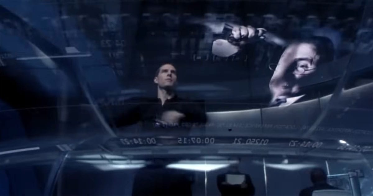 Tom Cruise analyzing precognitive crime footage on futuristic screens in Minority Report.