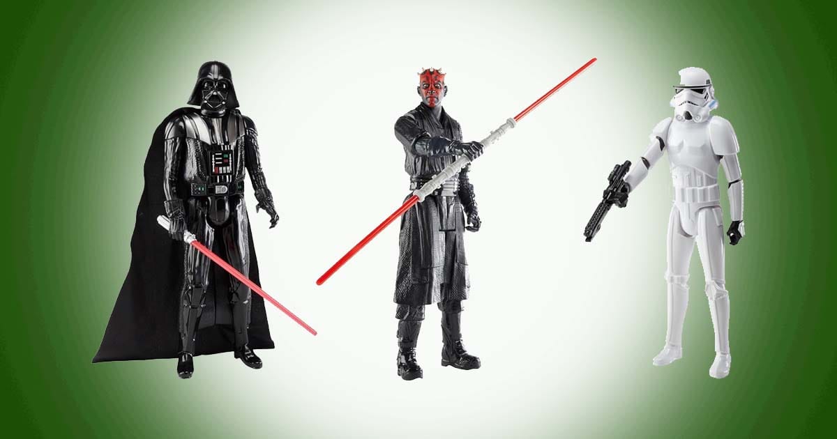 Star Wars action figures of Darth Vader, Darth Maul, and a stormtrooper posed with lightsabers and blaster.