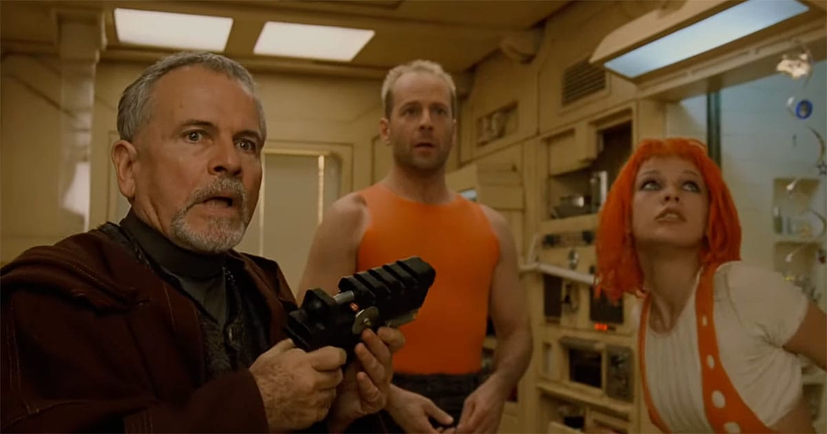 Korben Dallas, Leeloo, and Zorg inside futuristic apartment in The Fifth Element reacting to tense moment.