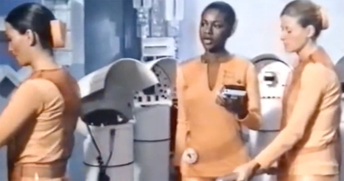 Workers in a controlled futuristic environment in "Brave New World" (1980) showing uniform roles and conditioned behavior.