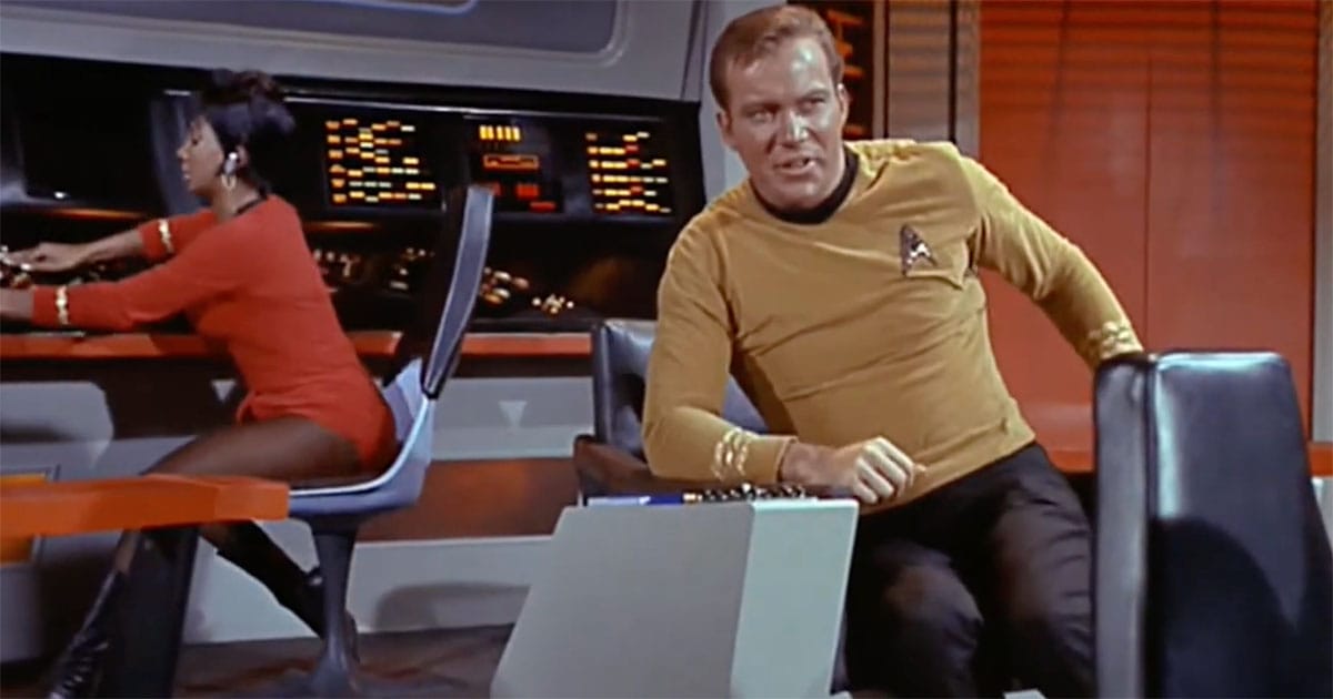 A still from “Star Trek The Original Series” showing Captain Kirk on the Enterprise bridge while Uhura operates her station during a tense moment of command and observation.