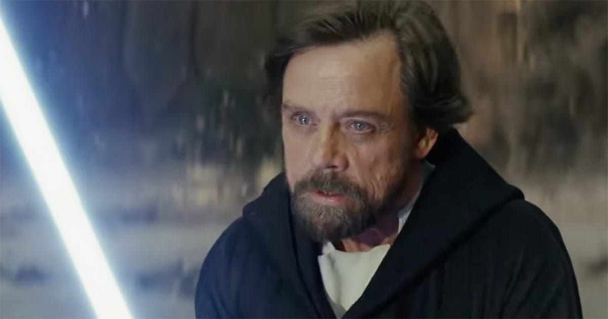 Close-up of Luke Skywalker holding a lightsaber in Star Wars, showing inner conflict tied to Grey Jedi themes in Legends lore.