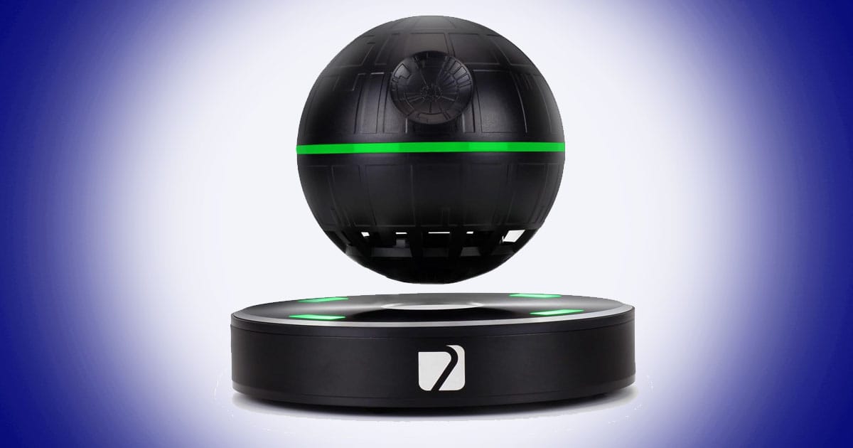 Levitating spherical Bluetooth speaker with glowing green light and floating science fiction space station inspired design.