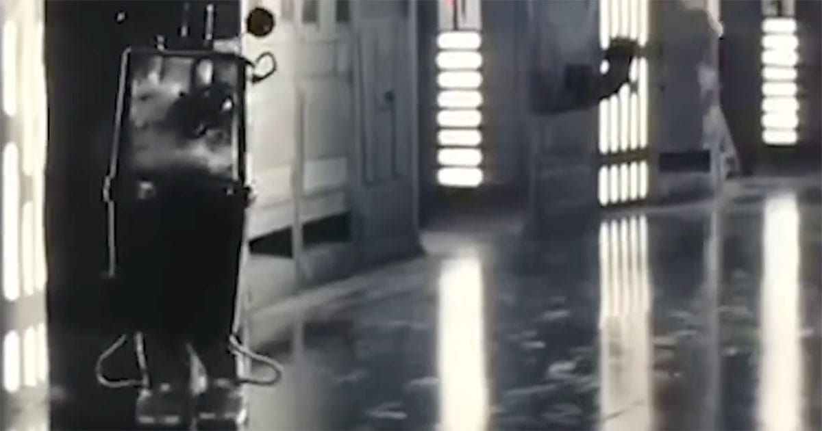 Gonk Droid standing alone in a bright corridor in "Star Wars"