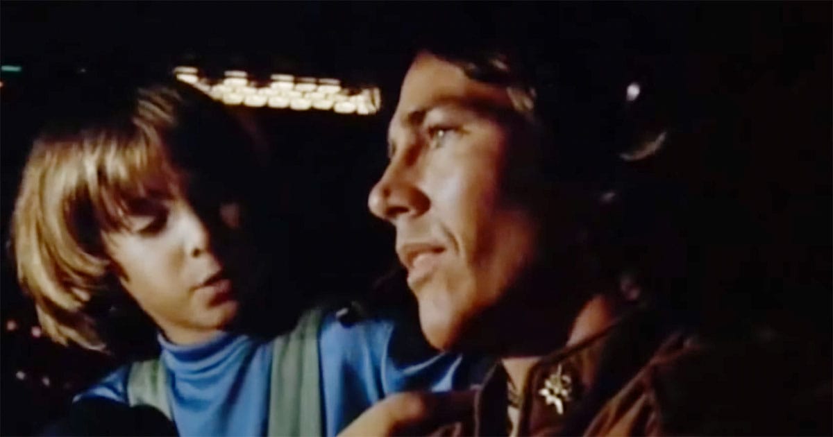 Apollo speaking with a child aboard the refugee fleet in the 1978 science fiction film "Battlestar Galactica"