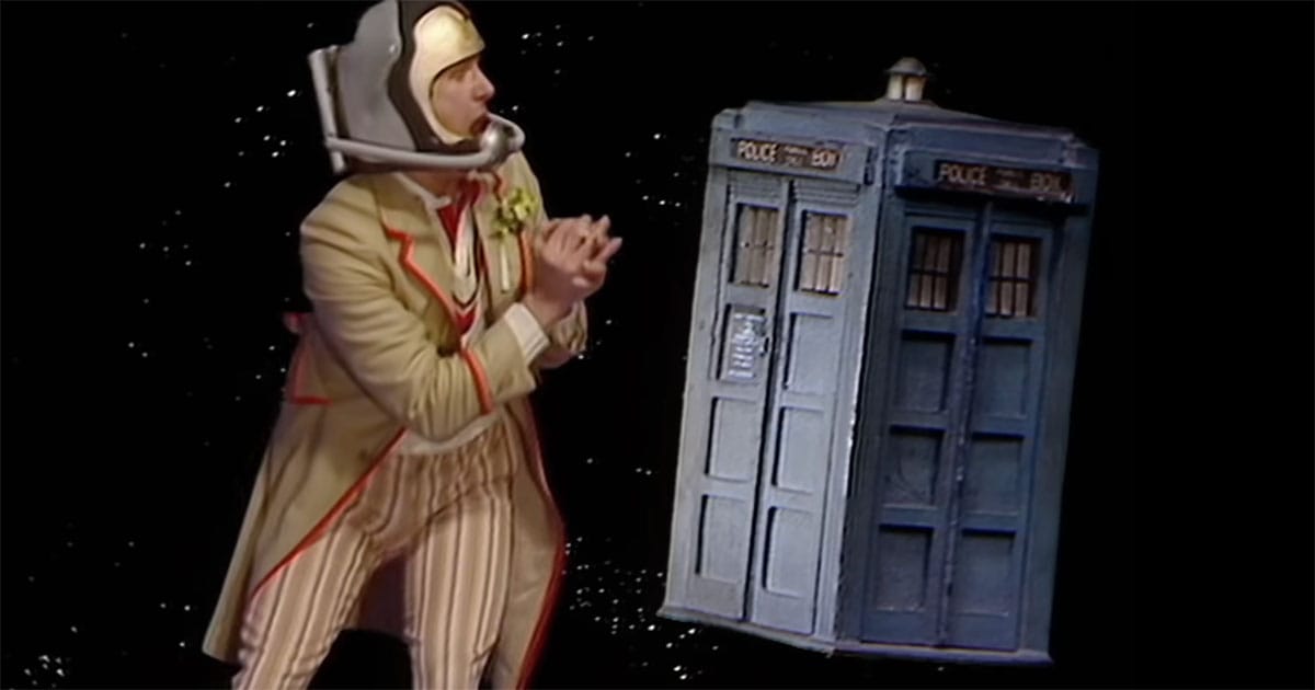 The Doctor floating beside the TARDIS in space.