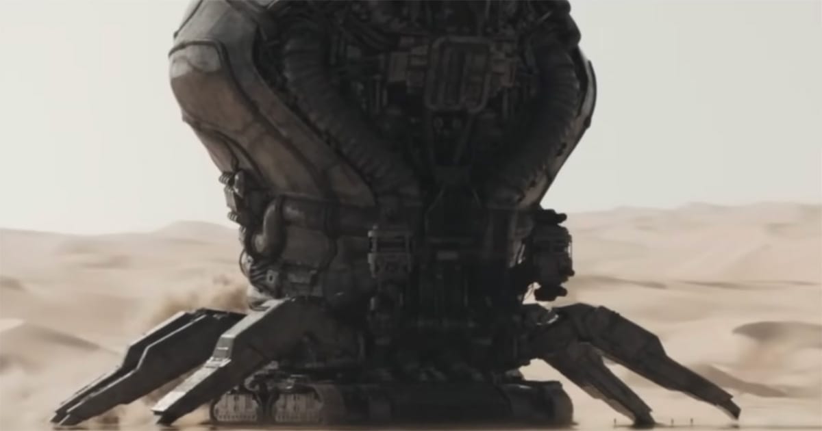 Massive industrial machinery towers over the desert landscape of Arrakis.