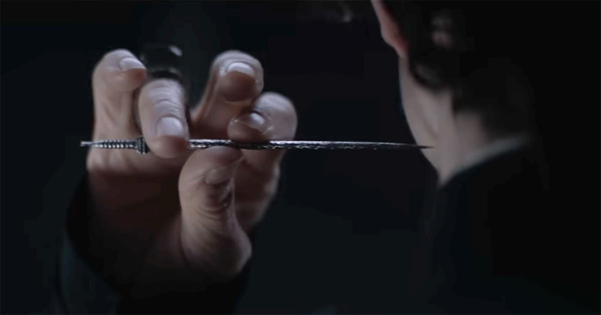 Close up of Gom Jabbar needle held at neck during test in "Dune"