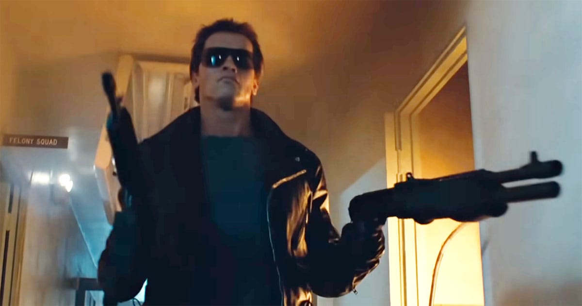 Arnold Schwarzenegger as the Terminator carrying firearms through a dimly lit hallway in "The Terminator."