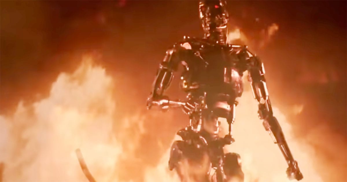 The Terminator endoskeleton walking through flames in a fiery scene from "The Terminator."