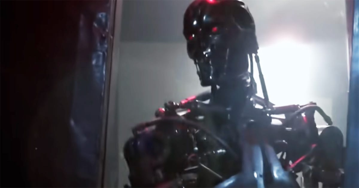 The exposed Terminator endoskeleton with glowing red eyes standing inside a building in "The Terminator."