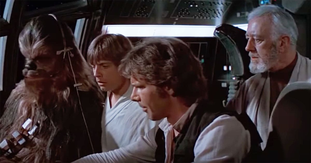 Han Solo sits in the Millennium Falcon cockpit with Luke Skywalker, Obi-Wan Kenobi, and Chewbacca in "Star Wars: A New Hope."