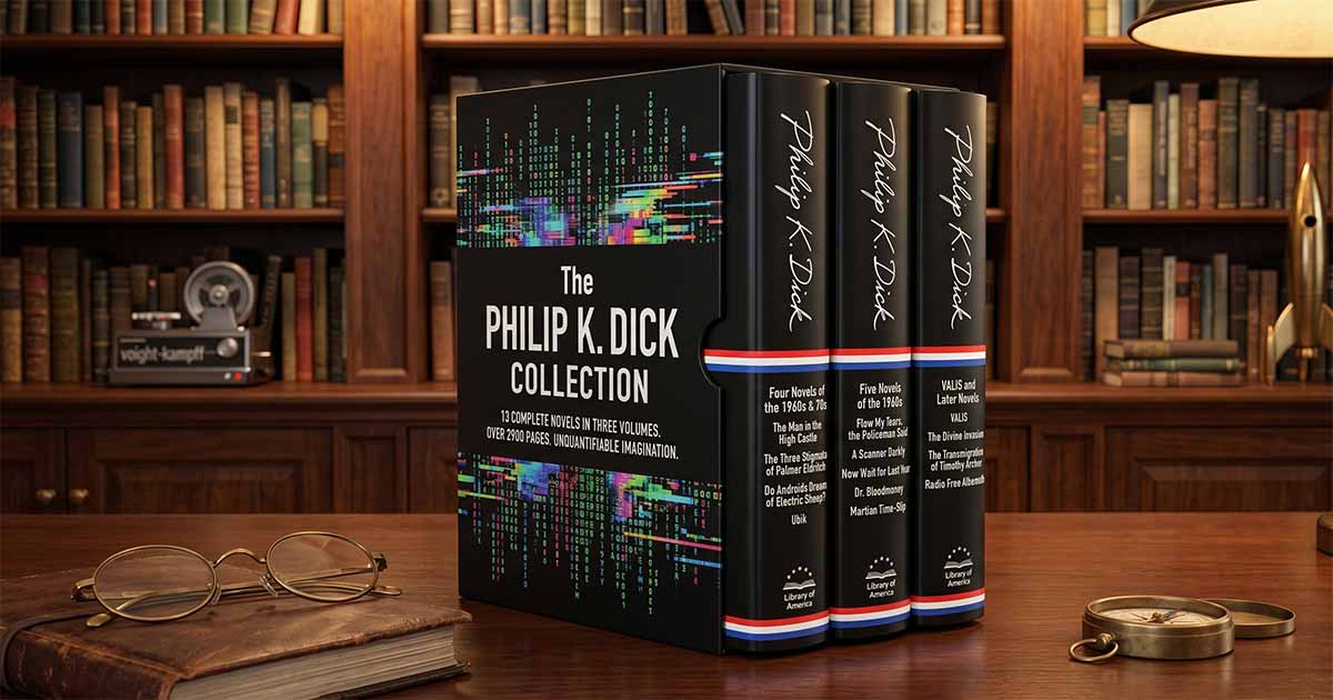 The Philip K. Dick Collection boxed set featuring three Library of America volumes displayed on a desk in front of a classic science fiction library bookshelf.