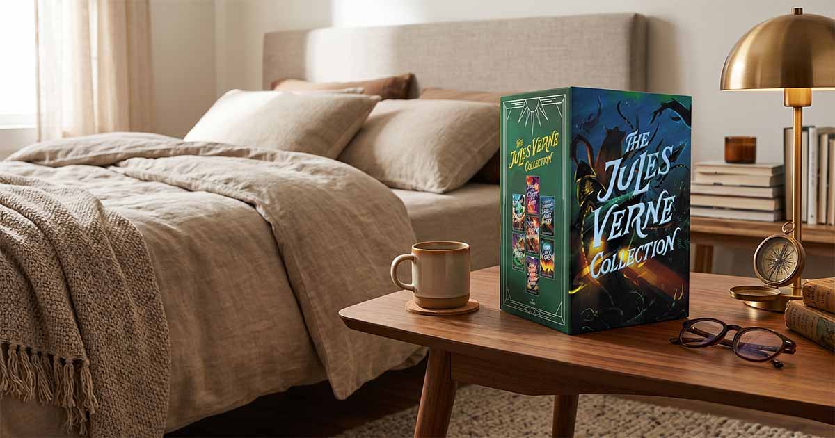 The Jules Verne Collection boxed set displayed on a bedside table beside a coffee cup, lamp, and reading glasses in a cozy reading room.