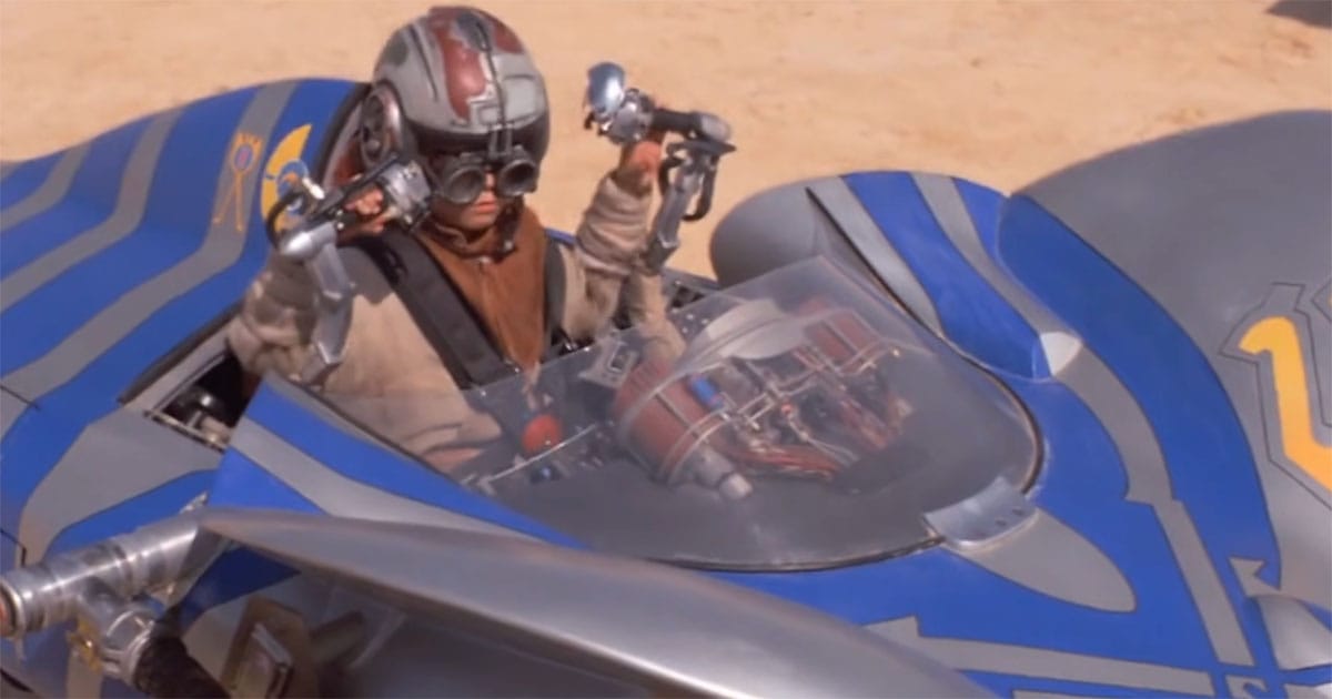 A podracer pilot prepares for competition inside a high-performance cockpit with visible mechanical components beneath the canopy.