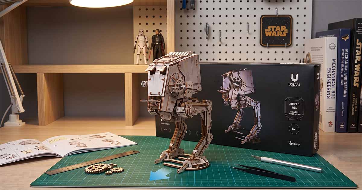 AT-ST Walker wooden puzzle displayed on a workbench with assembly tools and instructions.