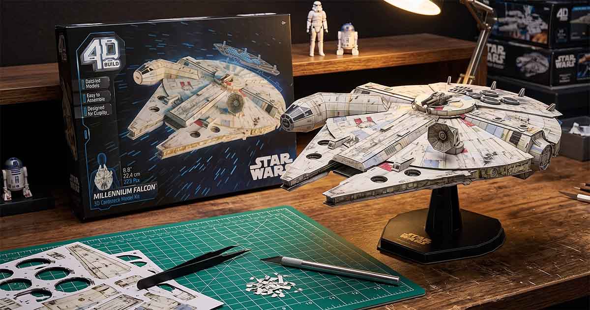 4D Build Millennium Falcon model displayed on a stand beside its puzzle kit box.
