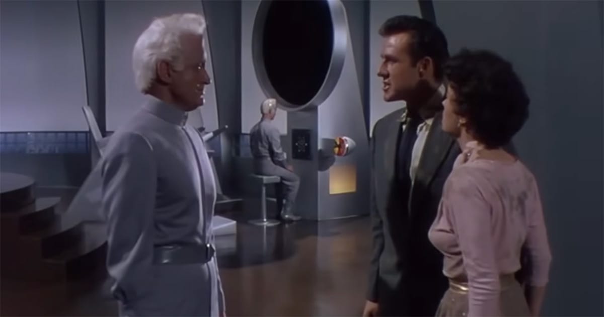 Exeter confronts Cal Meacham and Ruth Adams inside the sleek Metalunan research complex in This Island Earth (1955).