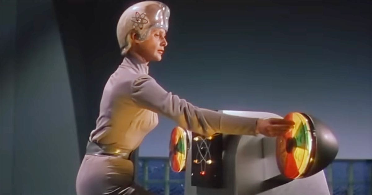 A Metalunan technician operates an advanced control console while wearing the civilization's distinctive transparent headpiece in This Island Earth (1955).
